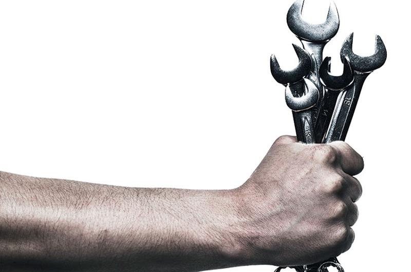 Hand holding Spanners to highlight servicing of tube bending machines by Langbow